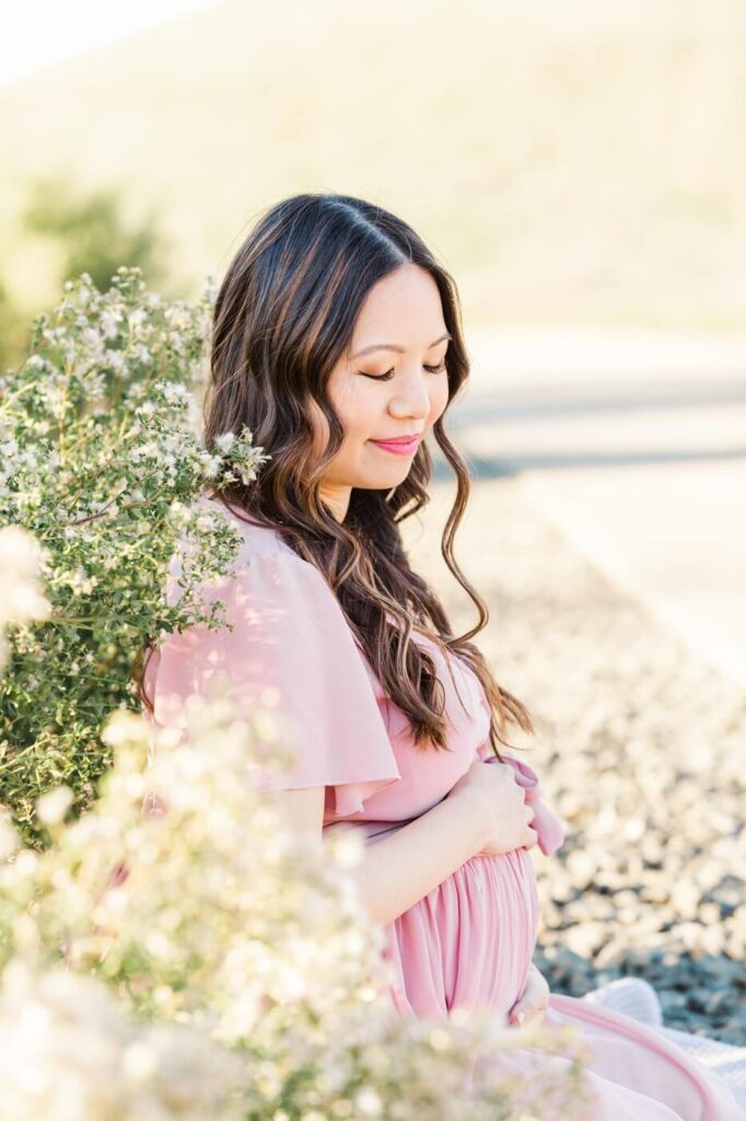 maternity photography of woman in pink dress