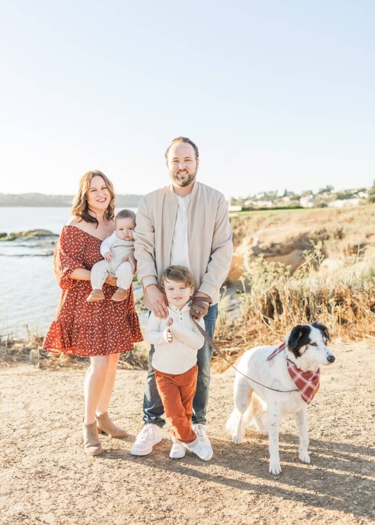 Family taking photos at a beach along the bay in the San Francisco Bay Area