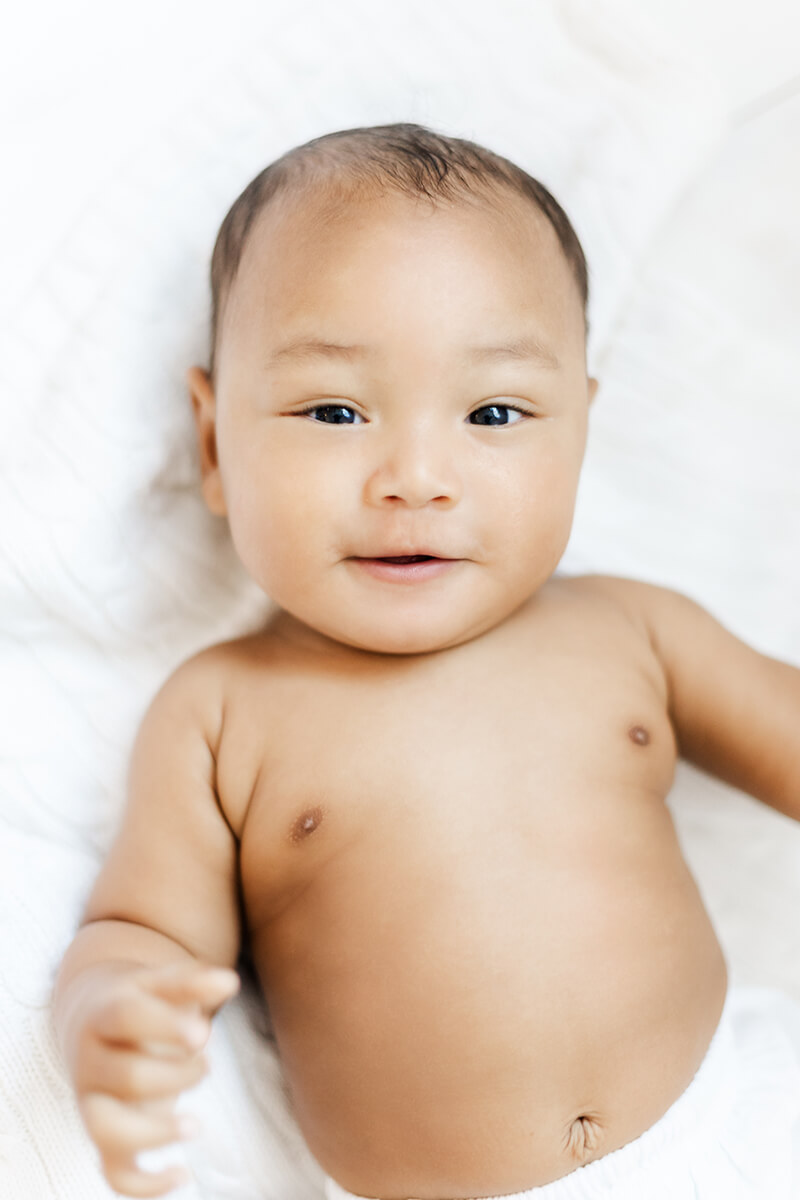 Little baby boy lying down by Bay Area Family Photographer