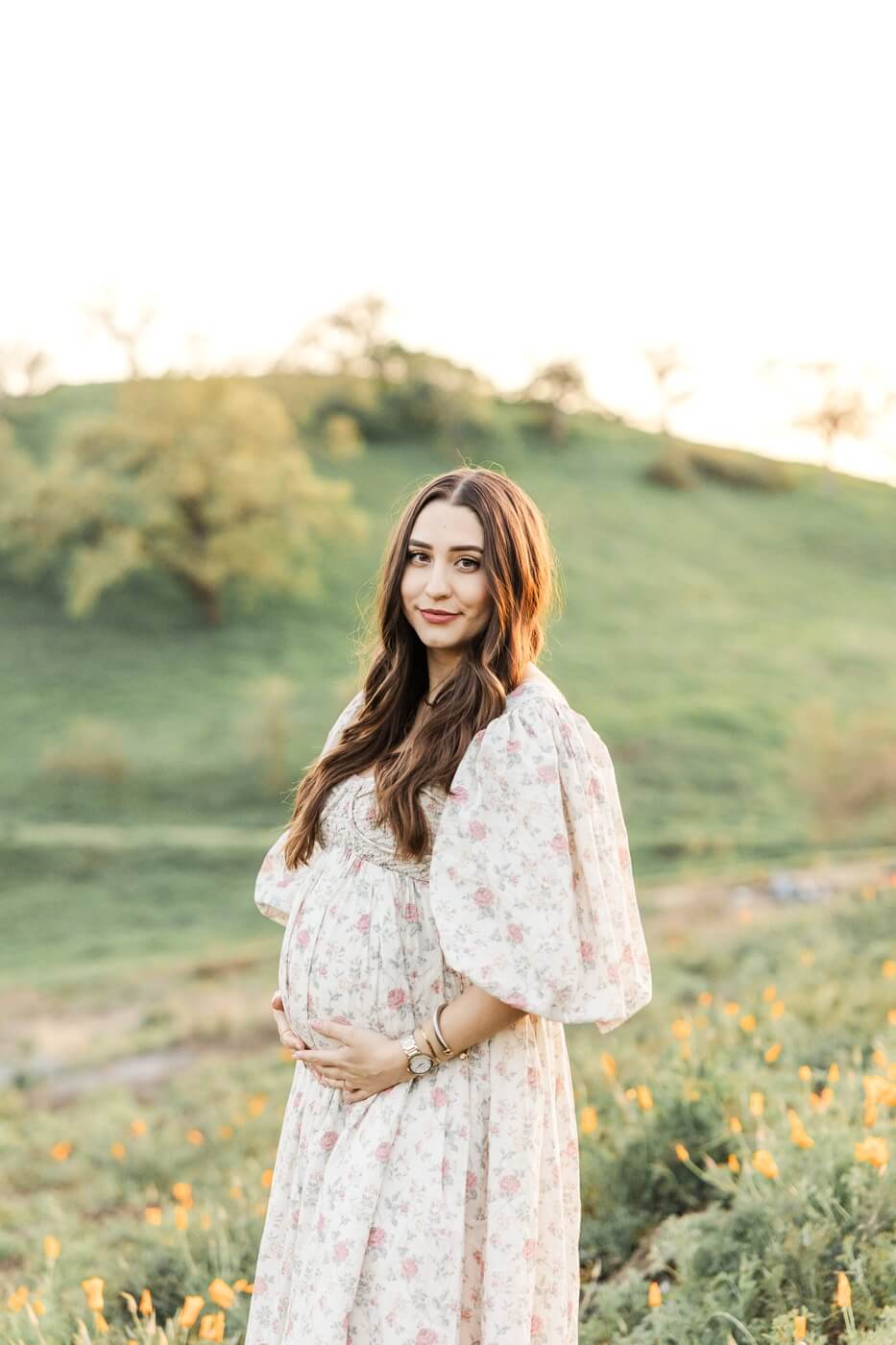 Mom holding pregnant belly in a field in Walnut Creek, California